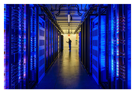 Tech at the end of a long line of server racks
